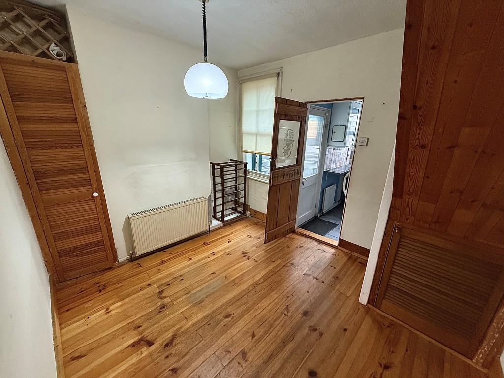 Lot: 76 - TWO-BEDROOM MID-TERRACE HOUSE FOR IMPROVEMENT - Dining room with staircase and window